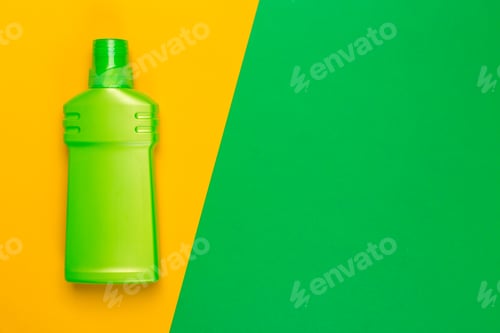 Preview: Bright green bottle on yellow and green background showing cleaning product theme