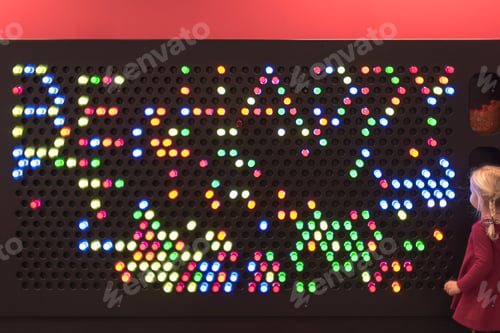 Preview: Colored pegs on children’s light board spells Be Happy