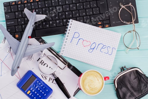 Preview: Modern workspace set with stationery plane cup of coffee on blue background.