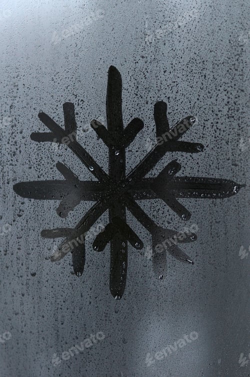Preview: The image of the snowflake is drawn with a finger on the surface of a misted glass window.