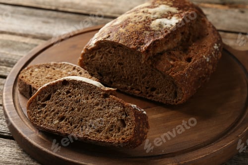 Preview: Pieces of fresh rye bread on wooden table, closeup