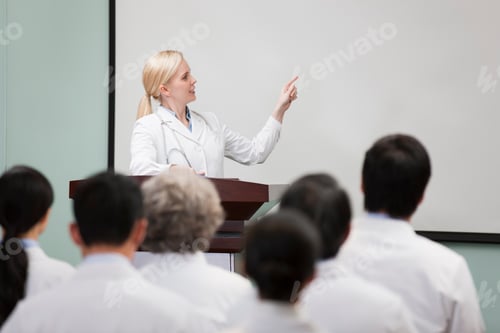 Preview: Female doctor giving speech in boardroom