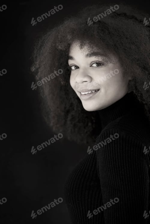 Preview: African beauty. Smiling young african-american woman in black clothes isolated on dark background