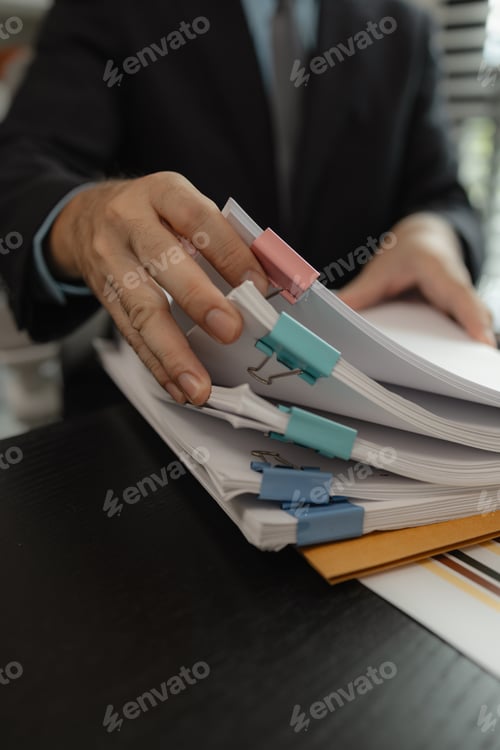 Preview: A group of business people sit together in their office