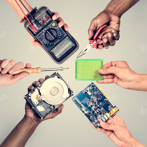 Preview: Group of hands holding computer electronics parts on gray background