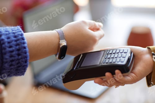 Preview: Woman Paying Contactless with Smart Watch at Shop