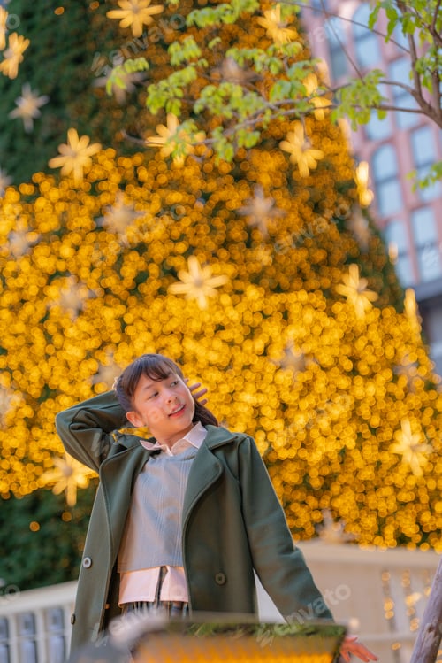 Preview: A joyful young girl in a green coat making playful expressions