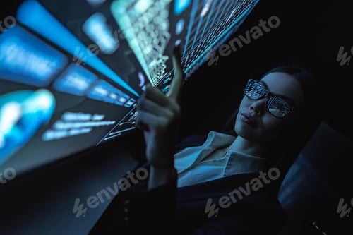 Preview: The business woman works with graphics on a sensor screen.
