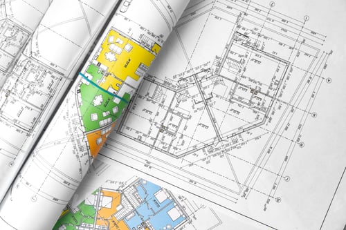 Preview: Architectural construction plans paper on table close up