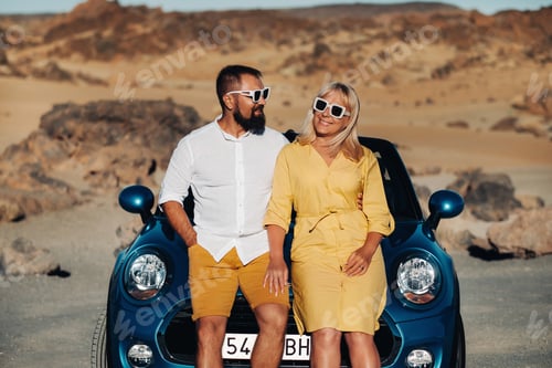 Preview: a woman and a man wearing glasses in a convertible car on a trip to the island of Tenerife. The