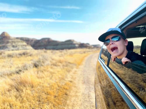 Preview: Kid on a family road trip looking through the window