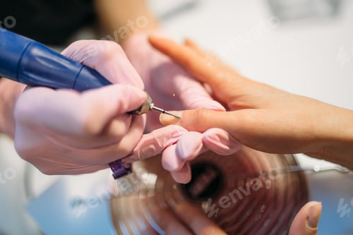 Preview: Beautician polishing nails of client, top view