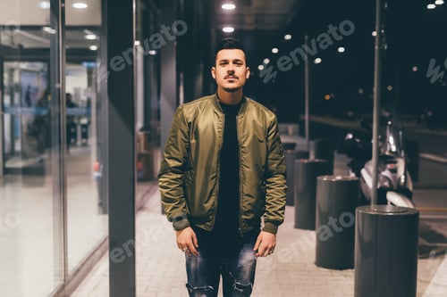 Preview: Young Man Posing in Green Jacket at Night