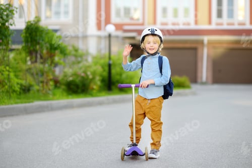 Preview: Little child in safety helmet riding scooter to school.