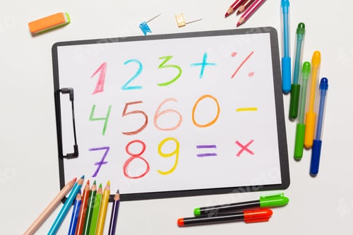 Preview: Colorful math problems written on paper with stationery and colored pencils nearby