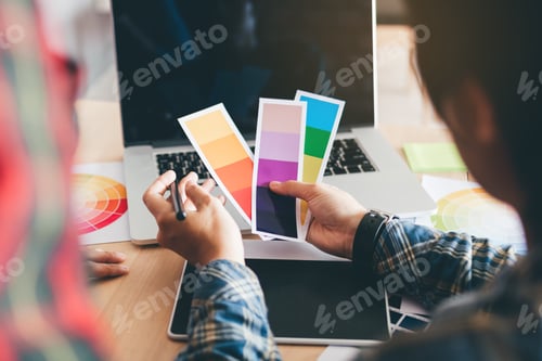 Preview: Rear view of designer choosing colors and working together.