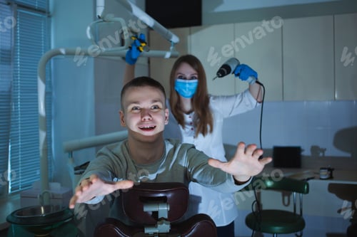 Preview: creepy dentist scares client with drill, fear and horror, Halloween. man is afraid of doctor, wants