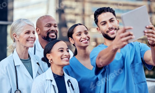 Preview: Colleagues who became friends. Shot of a group of doctors taking a selfie in the city.