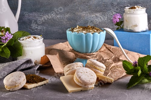 Preview: Wooden cutting board topped with macarons , chocolate , yogurt and grapes