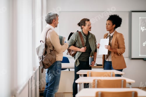 Preview: Adult student and their African American professor communicating after a class in the classroom.