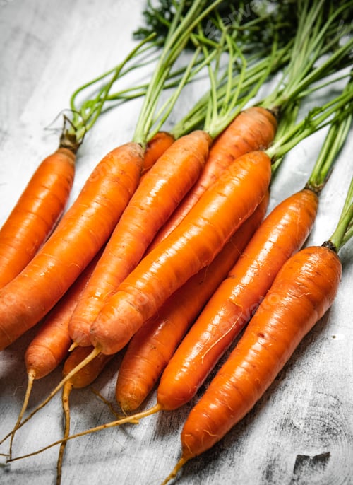 Preview: Fresh carrots on wooden table.