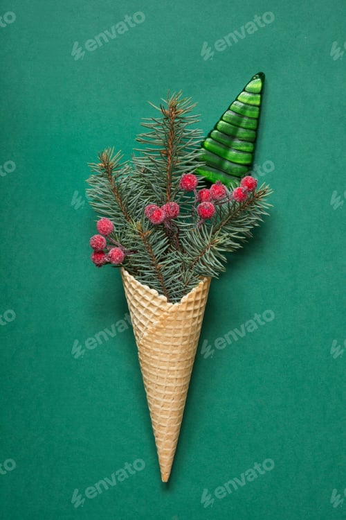 Preview: Christmas candy cane, red balls in ice cream cone on green. Xmas holiday card. Top view.