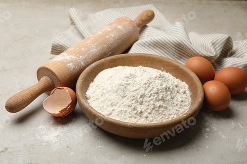 Preview: Rolling pin, flour and eggs on light grey background