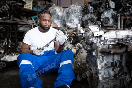 Preview: Men repairing car engine in auto repair shop, Selective focus.