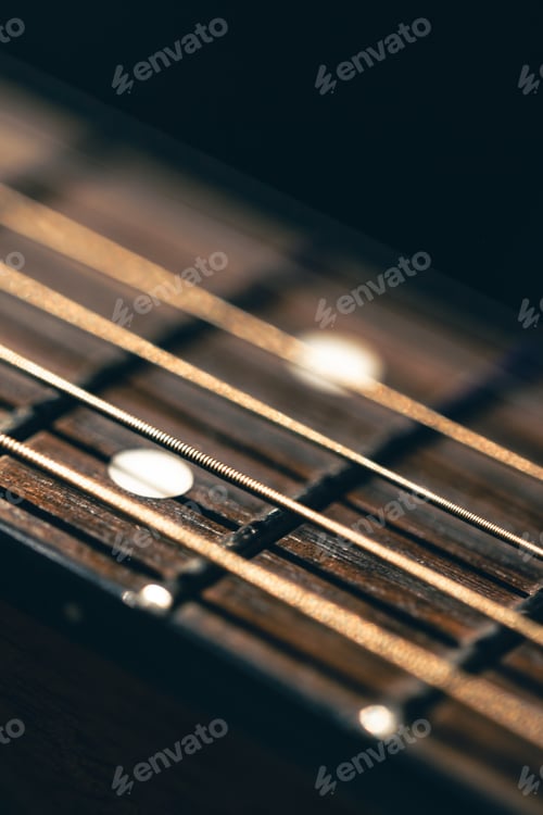 Preview: Part of an acoustic guitar, guitar fretboard on a black background.