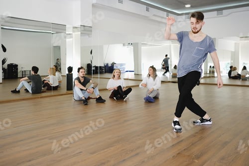 Preview: Group of young modern dancers dancing in the studio