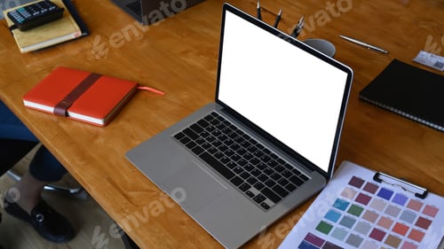 Preview: Mock up computer laptop and paperwork on wooden table at creative workplace.
