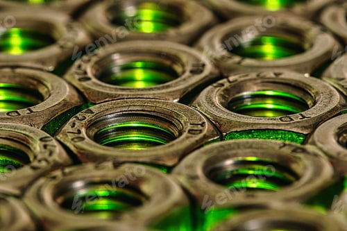 Preview: Closeup shot of metal screw nuts with light green lights coming under it