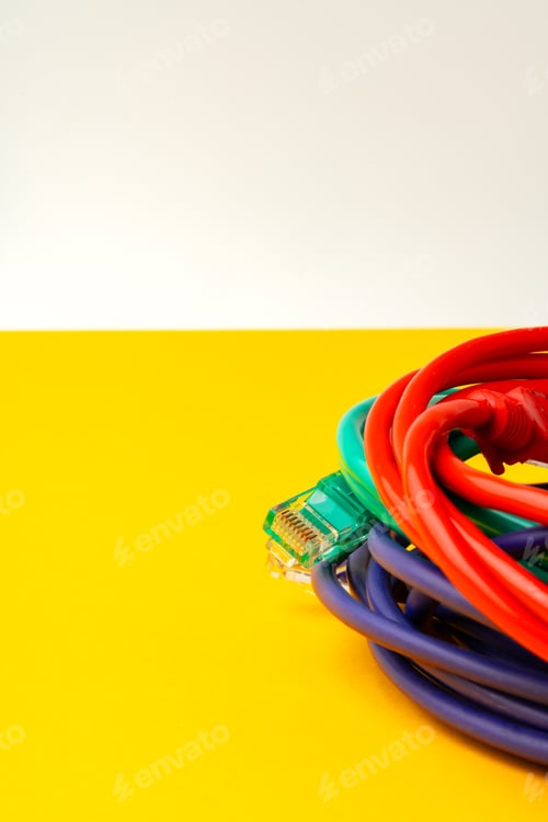 Preview: Network cable on yellow background studio shot