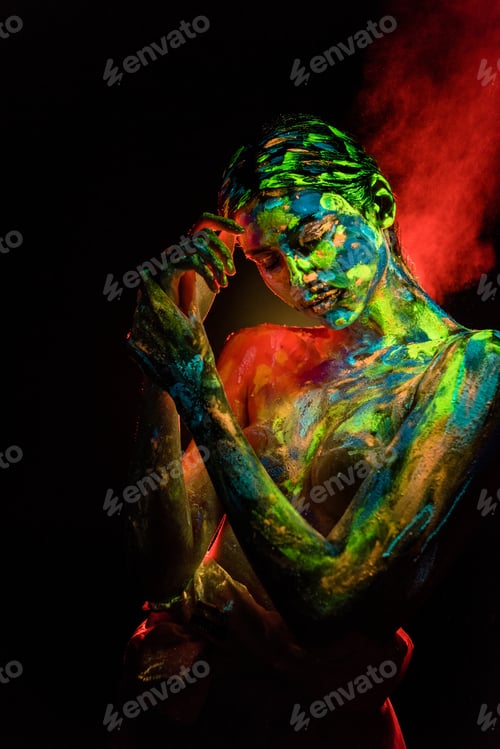 Preview: portrait of beautiful woman with colorful ultraviolet paints on body on black backdrop