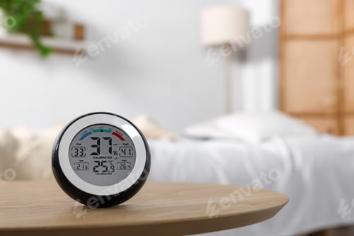 Preview: Digital hygrometer with thermometer on wooden table indoors. Space for text