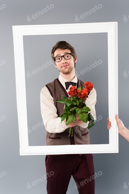 Preview: man in white frame holding bouquet of roses on grey background