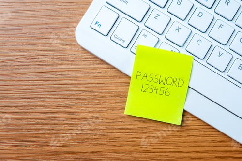Preview: Sticky note with the word "password 123456" on a laptop keyboard.