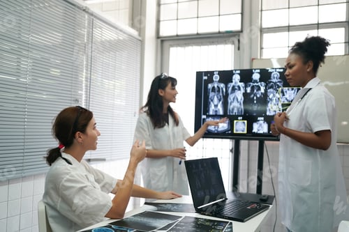 Preview: Group of doctors looking at X-ray on medical conference, discussing issues