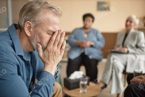 Preview: Crying Senior Man in Group Therapy Session