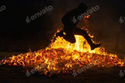 Preview: Summer solstice celebration jumping into the fire. Burning flames