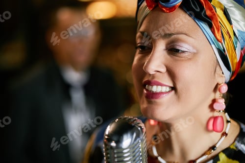 Preview: Smiling Multiethnic Woman in Headwrap Singing with Band in Jazz Club Indoors