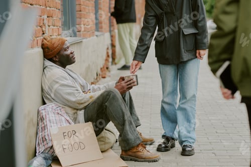 Preview: Homeless Black Man Sitting on Street Receiving Money from Stranger