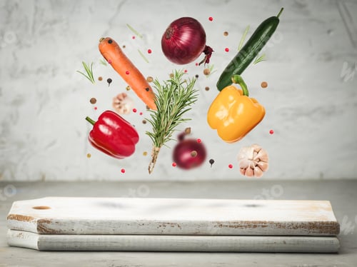 Preview: fresh vegetables onions, carrots, yellow and red peppers, a bunch of rosemary levitate