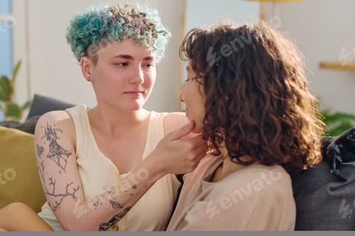 Preview: Young serene woman with myoelectric hand looking at her girlfriend