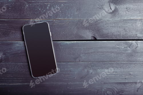 Preview: Close up photo of smartphone on black wooden table
