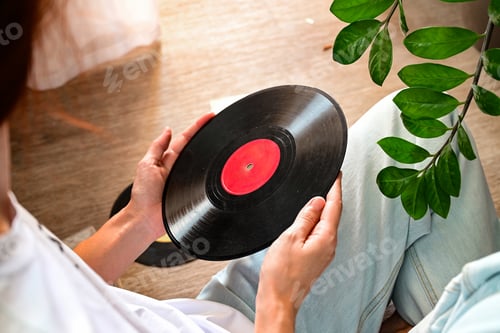Preview: Vinyl records on a wooden table. The girl's hand examines vinyl records. Retro style.