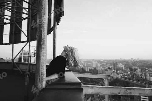 Preview: Romantic and beautiful caucasian woman in stylish clothes on the rooftop outdoor portrait.