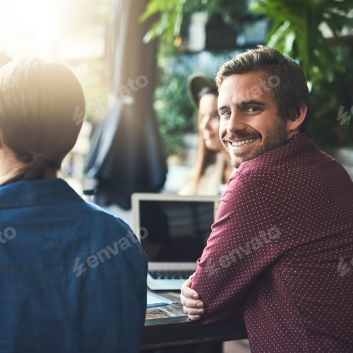 Preview: Portrait of a young designer having a meeting with his colleagues at a coffee shop