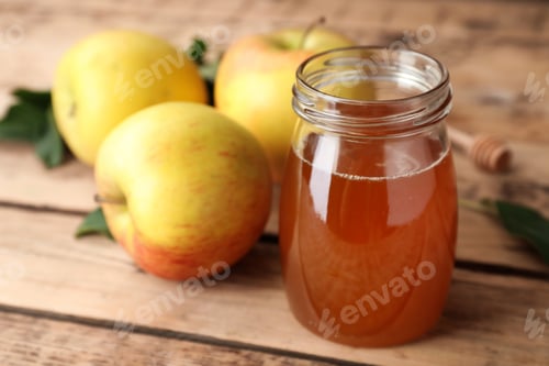 Preview: Jar of honey and apples on wooden table