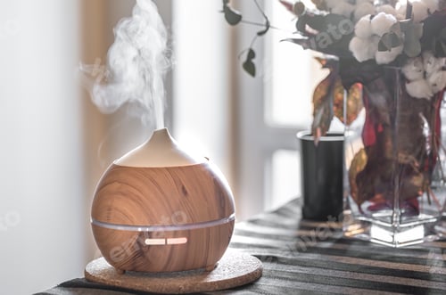 Preview: Modern oil aroma diffuser in the living room on the table.